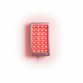 LED red light therapy panel glowing on white background